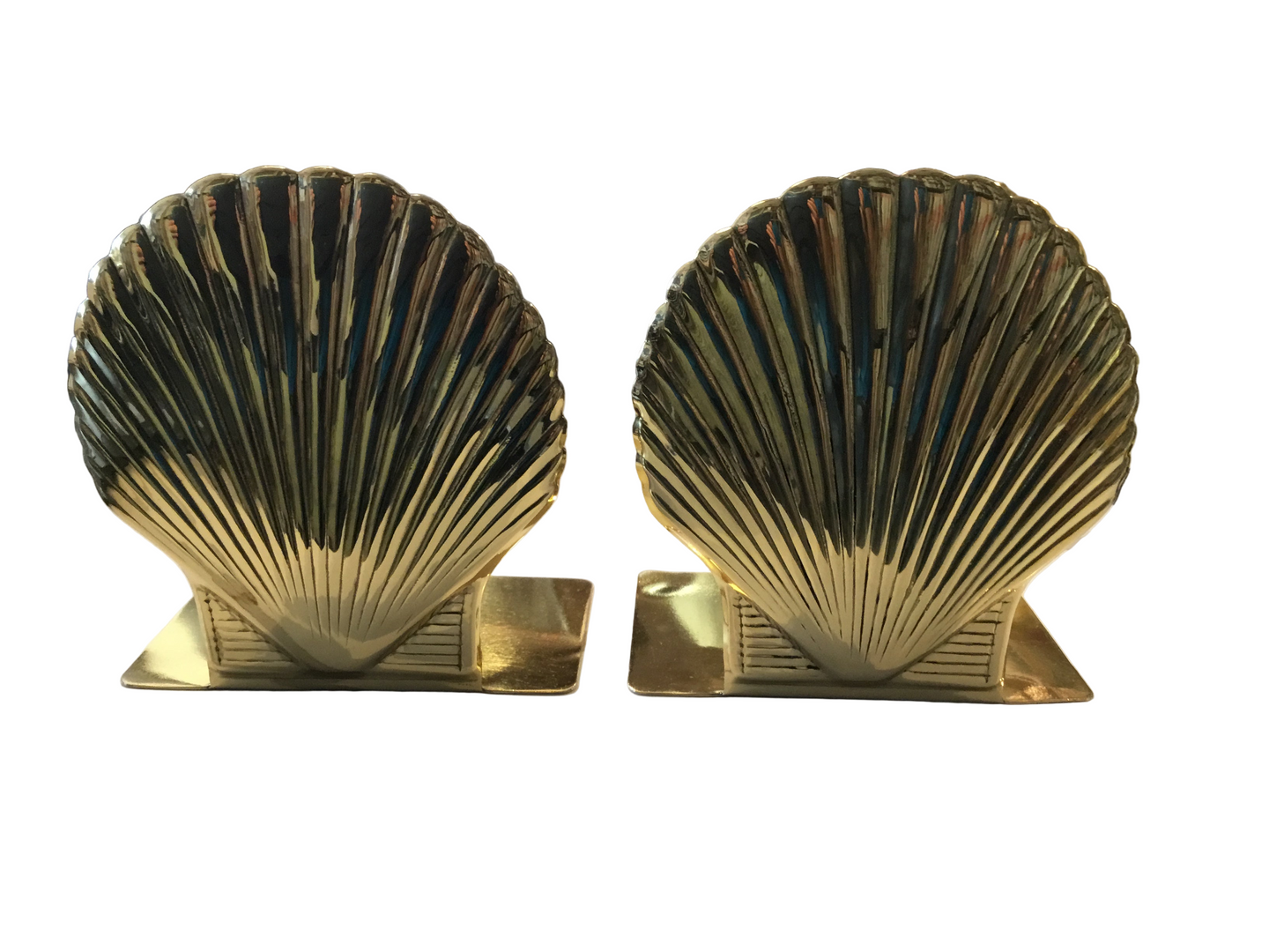 pair of cast brass shell bookends with a lacquerd finish-