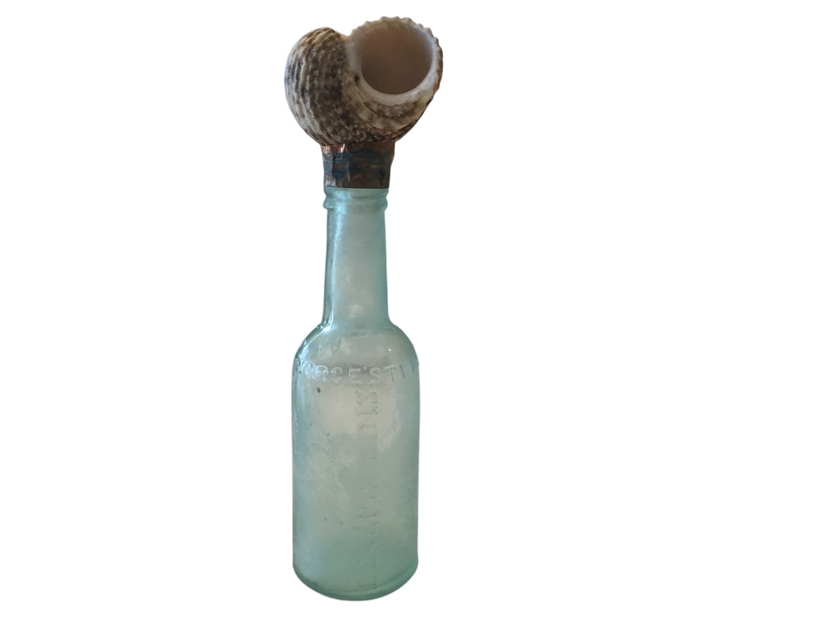 vintage glass medical bottle with snail top