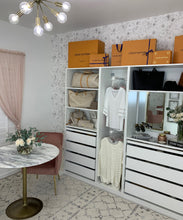 Load image into Gallery viewer, Peonies &amp; Anemones White Floral Wallpaper is behind some shelving and clothes in this closet and office space
