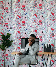 Load image into Gallery viewer, 1980's Office Wallpaper featuring calculators, staplers, computers, phones on a messy desk • retro wallpaper insitu