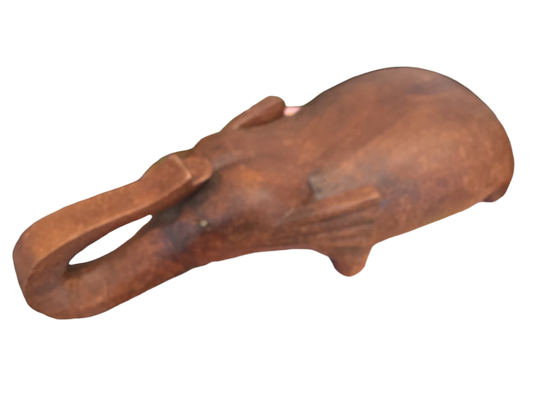 carved wooden elephant with metal tusks